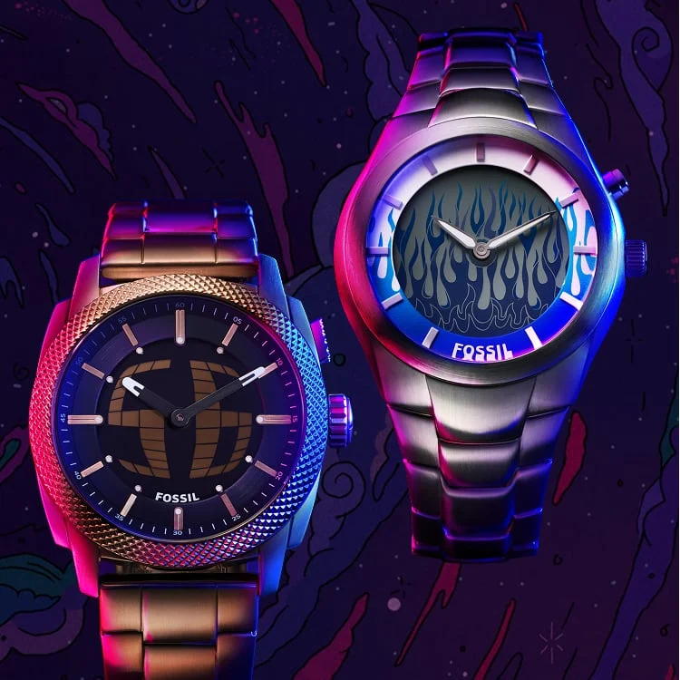 Three Fossil Big Tic watches, displaying an animated display of digital flames or scrolling digits. Each is housed in a sleek stainless steel case and highlighted by dramatic pink and blue lighting.