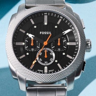 A close-up of the rugged Fossil Machine chronograph watch in a silver-tone finish with a black dial.