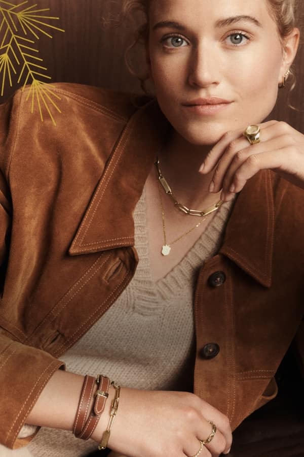 Fossil Heritage Jewellery A woman wearing gold-tone Fossil Heritage jewellery.