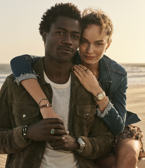 Man and woman wearing Fossil jewelry.