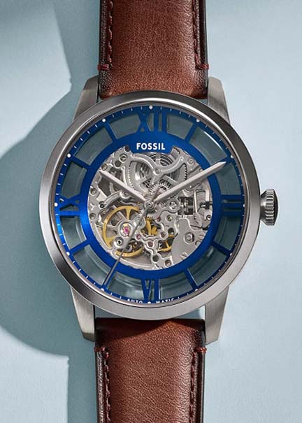 An automatic watch with blue dial on a brown leather strap.
