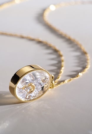 The shaky glitz necklace, featuring light-catching crystals that move inside the pendant.
