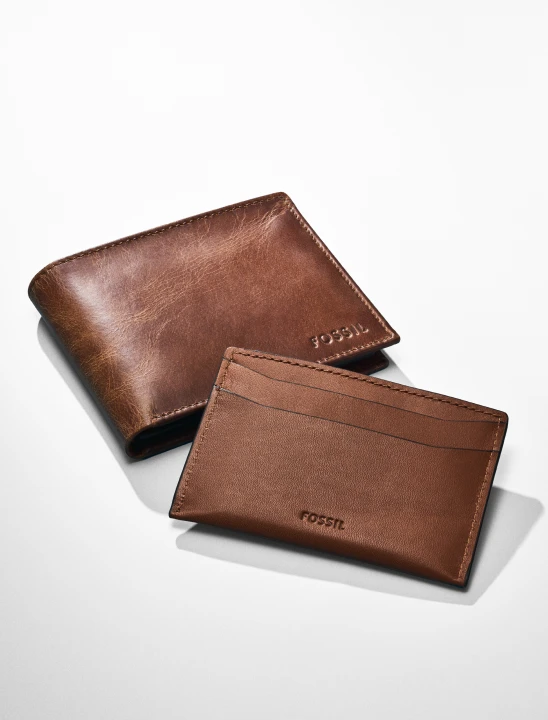 A Fossil brown leather bifold wallet.