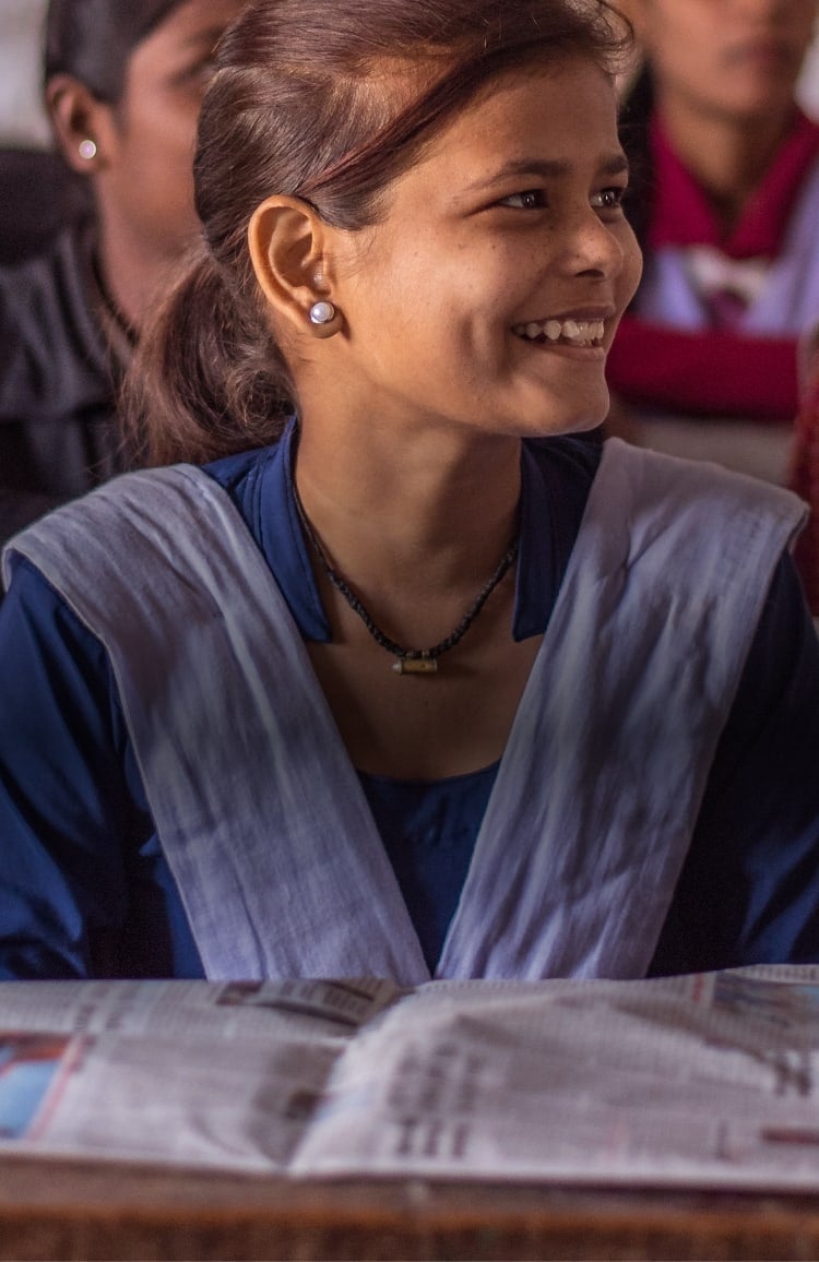 Three young people smiling.