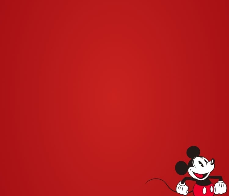 Une bannière rouge avec le Mickey Mouse de Disney qui semble marcher vers l’extérieur du cadrage de droite.