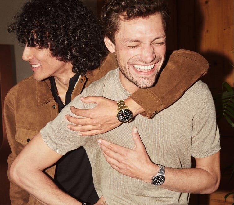 Gif of two men hugging and wearing Fossil watches.