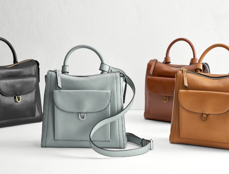 Four Parker Mini backpacks in black, blue, dark brown and light brown.