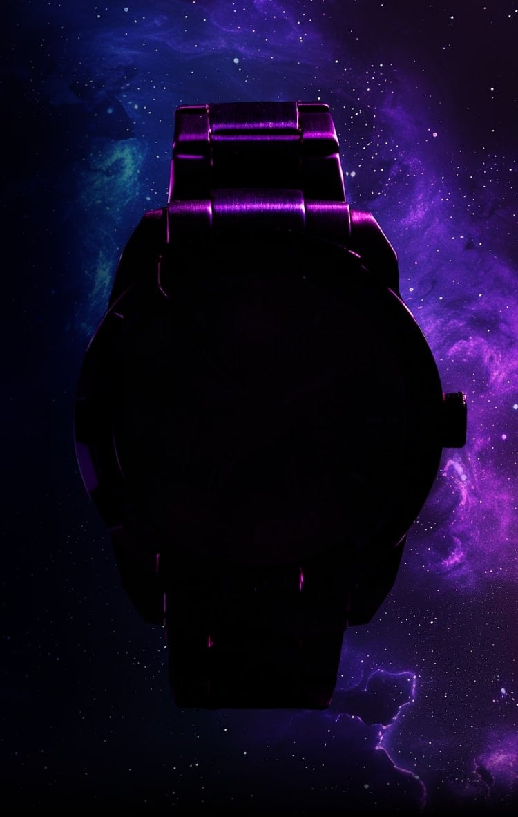 A blurred view of two watches on a dark, intergalactic background.