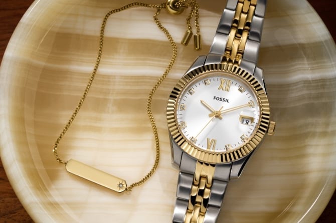 A gold-tone Raquel watch engraved on the back with: Seize the day.