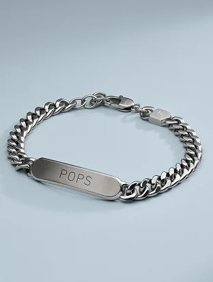 A Fossil stainless steel curb chain bracelet with an engravable ID plate.