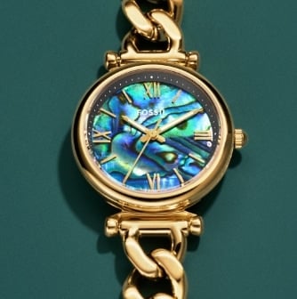 The gold-tone heart-shaped watch ring stacked on top of the silver-tone heart-shaped watch ring.