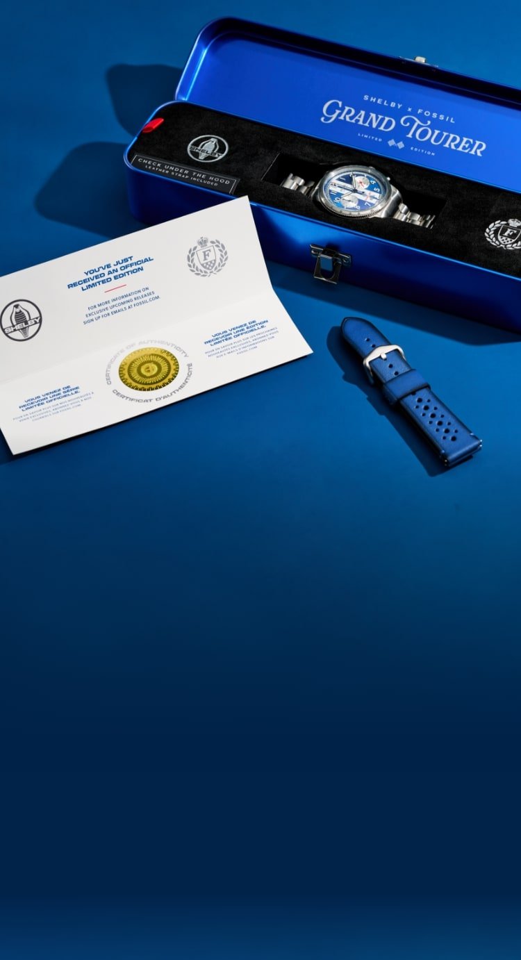 A royal blue auto toolbox-style display box, presenting the Shelby Grand Tourer watch inside, along with the interchangeable blue leather strap and certificate of authenticity.
