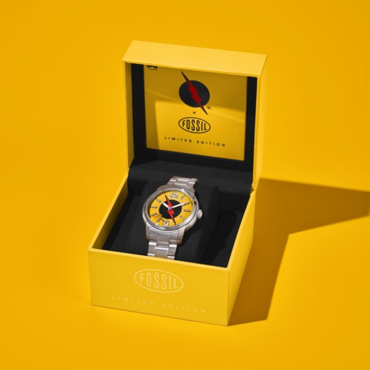 The Flash™ x Fossil limited edition watch packaging opening to reveal the Reverse-Flash watch inside.
