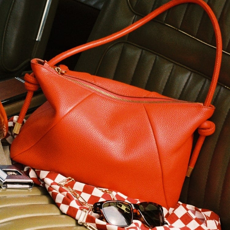 A women's shoulder bag in bright red pebbled leather.