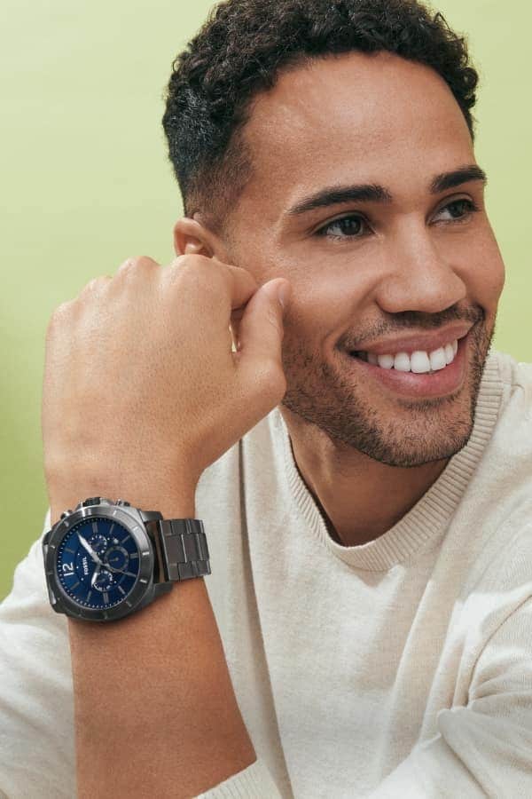 A man wearing a stainless-steel watch