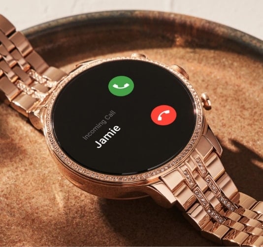 A rose gold-tone stainless steel Gen 6 smartwatch with incoming call on the dial.