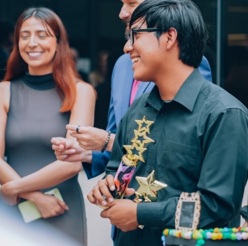 A man holding an award made of stars.