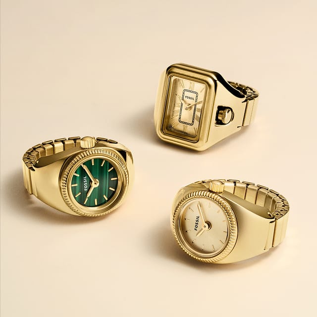 Three gold-tone watch rings: two with a round dial and one with a rectangular dial.