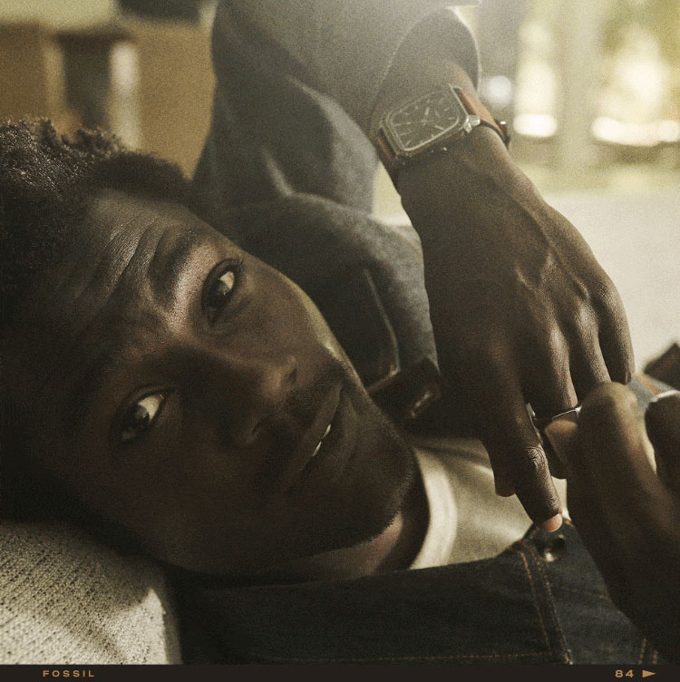 A man wearing the brown leather Inscription watch and a closeup of the Inscription watch with a two-layered dial and exposed screw on the topring.