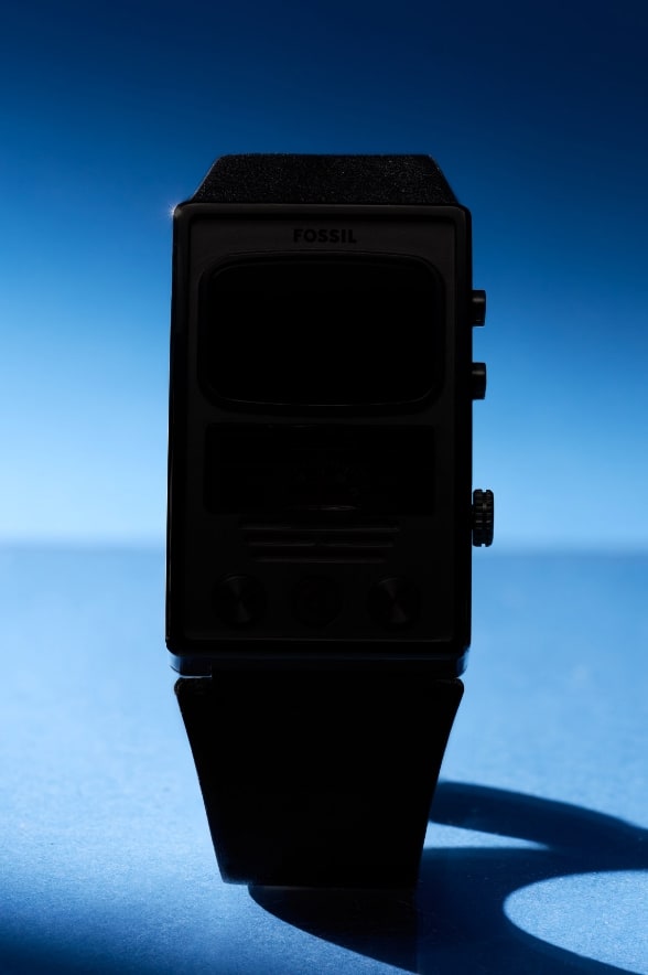 A blurred view of two watches on a dark, intergalactic background.