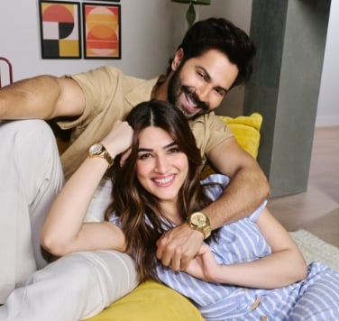 Kriti and varun showing gols tone watches on their wrist