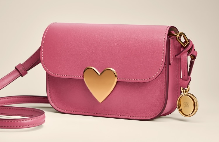 A pink leather Lennox bag with heart closure.