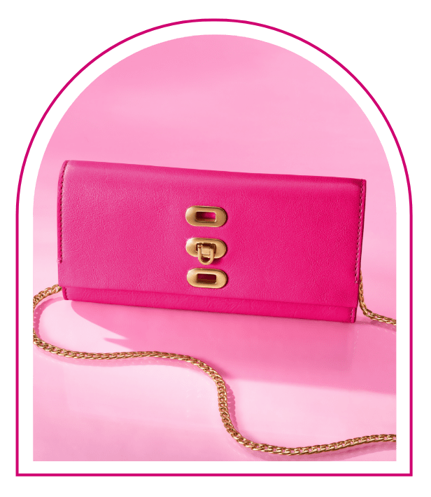 A pink background with a Barbie™ Mansion-inspired window. Inside the window sits our limited edition Barbie™ x Fossil Wallet Crossbody bag, featuring signature pink smooth-grain leather, a detachable chain crossbody strap and a fun colour-block interior with varying shades of pink.