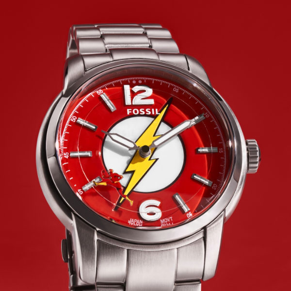 The Flash™ x Fossil limited-edition watch featuring a red dial, yellow lightning bolt emblem and The Flash running around the dial as the second hand.