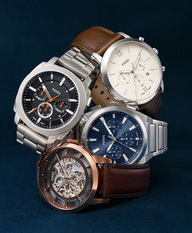 A row of men's watches featuring a variety of movement types, dials and bracelets.