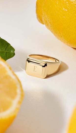 An engraved Fossil ring shown in a two-tone finish.