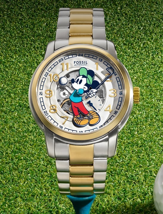Image of Fossil x Mickey Mouse Golf watch on a grass background.