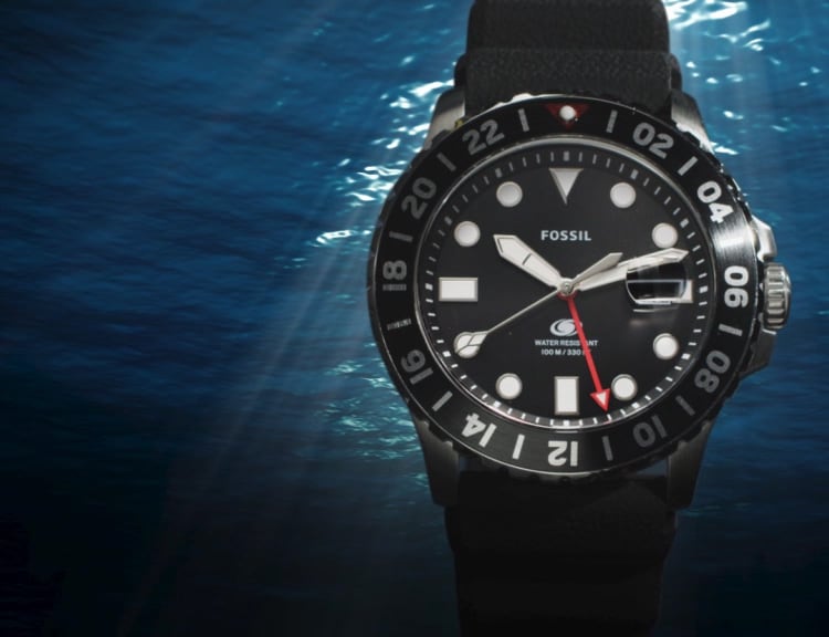 Fossil Blue GMT watch in the water.