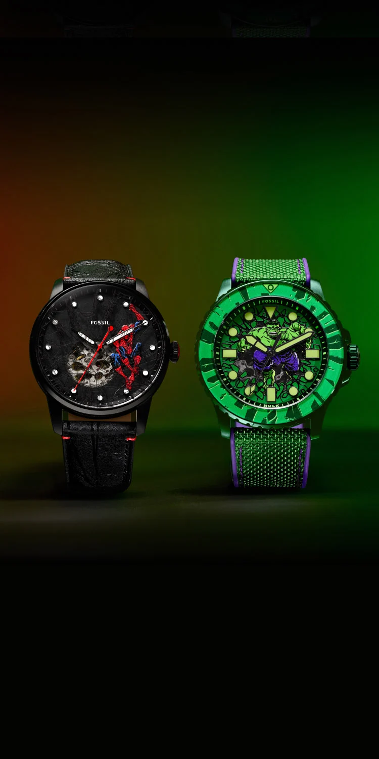 A collection shot of the Fossil limited-edition Mandalorian and Grogu watches, along with their display packaging.