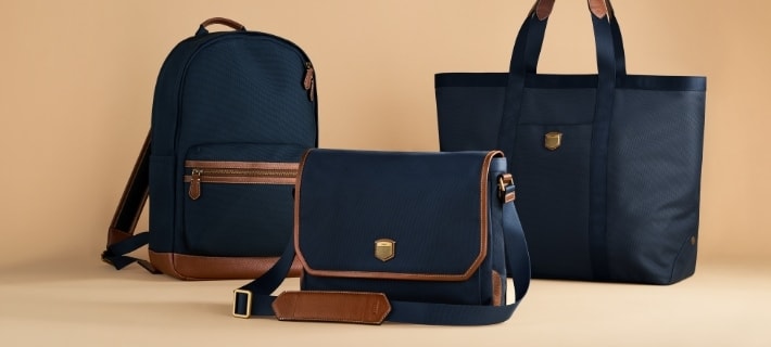 Three blue nylon travel bags.