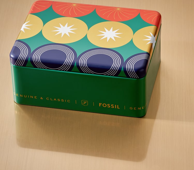 Gif of a brightly colored Fossil gift set tin opening to reveal a men's brown leather watch and brown leather bracelet.