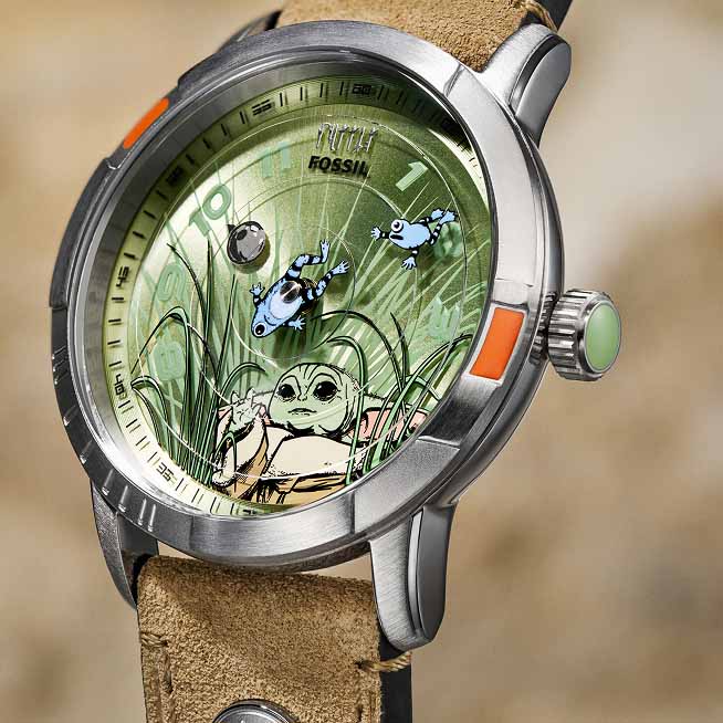 The Star Wars and Fossil Mandalorian collection, featuring the Fossil Limited-Edition Mandalorian and Grogu watches, along with their display packaging. 