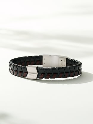 A black leather strap bracelet with stainless steel hardware.